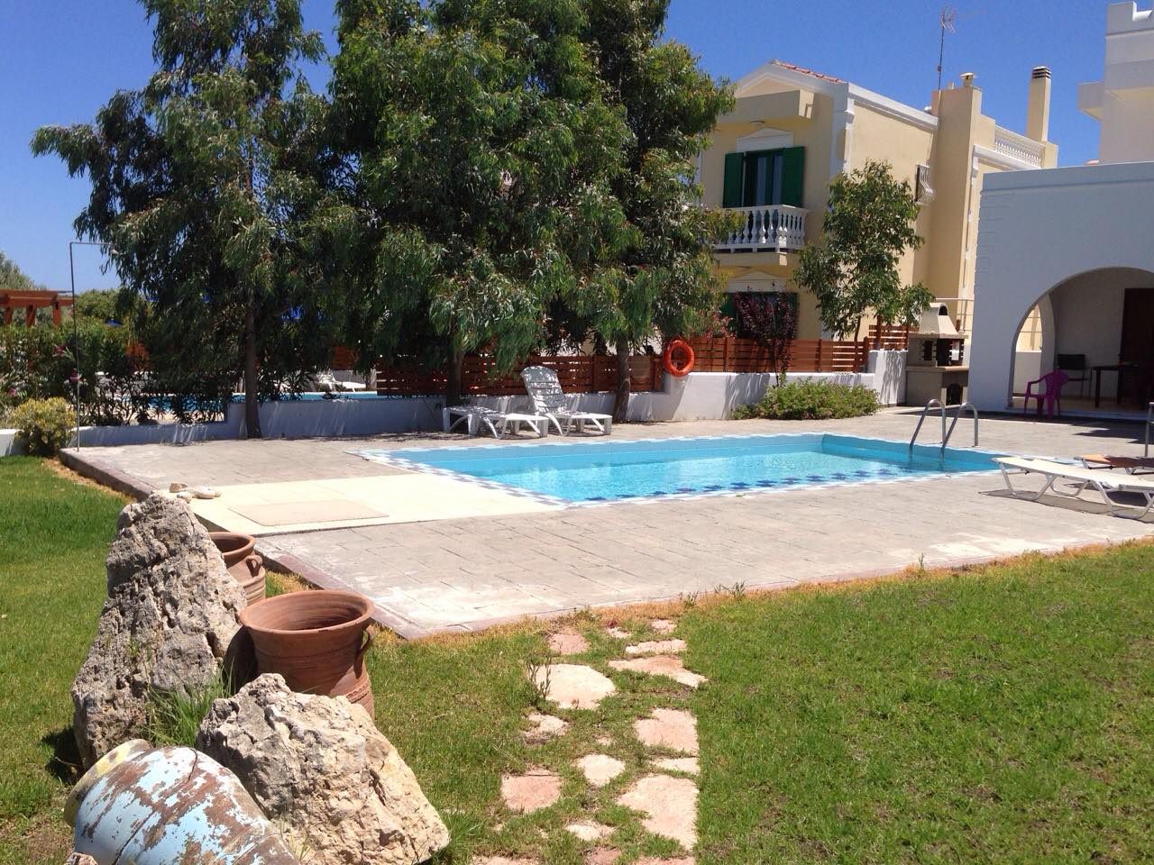 The shade trees between the garden and the pool