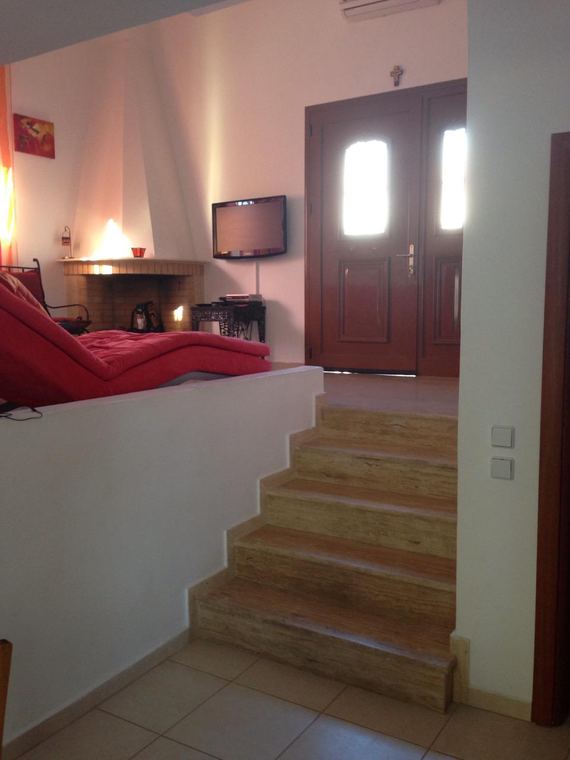 The living room, its stone fireplace and television