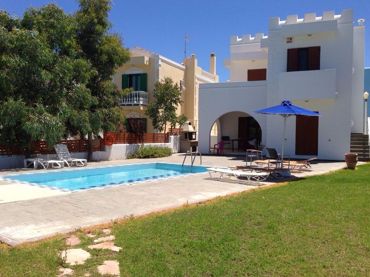 The villa seen from the garden, the pool in the foreground